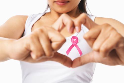 Heart framing on woman chest with pink badge